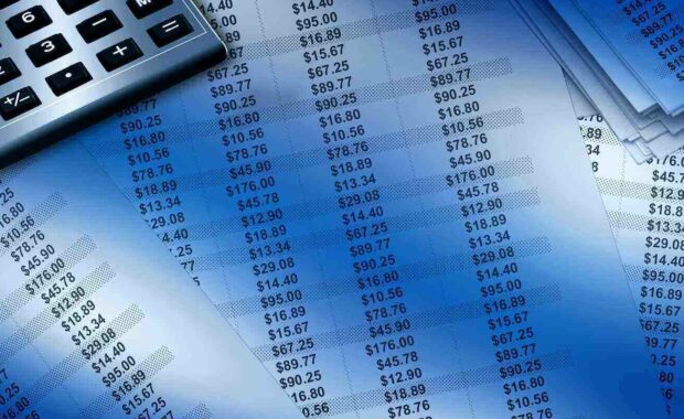 accounting papers papers with numbers are spread with a calculator in the image