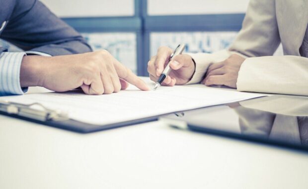 female hand signing contract