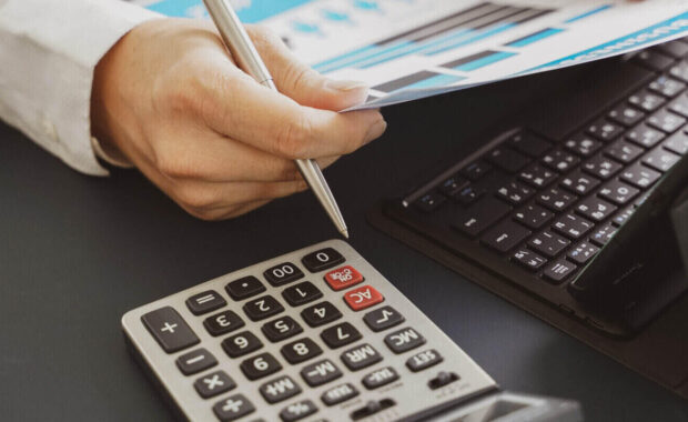 businessman doing finances and calculate about cost to investment