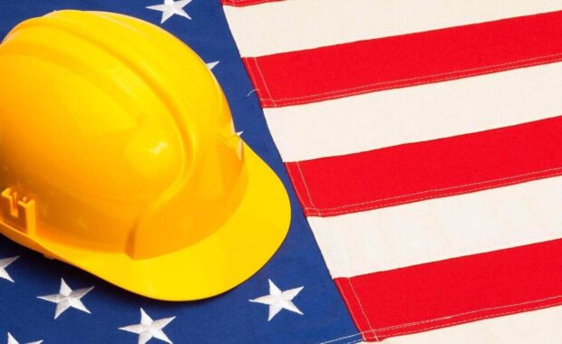 construction helmet laying over usa flag studio shoot