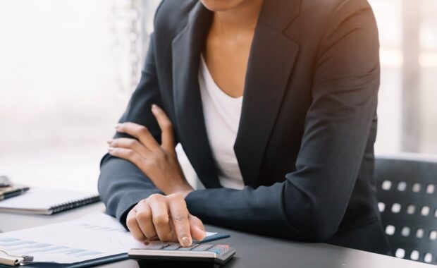 woman working on laptop and accounting financial report