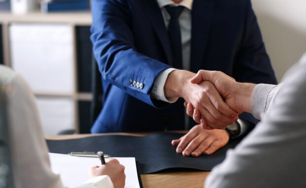 male lawyer working with clients in office