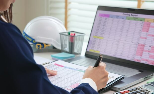 expert woman asian female people review data number costing managerial account prepare monthly actual cost variance report at tax audit office