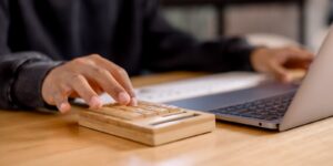 businessman calculating tax with laptop, calculator, and financial documents tax payment planning